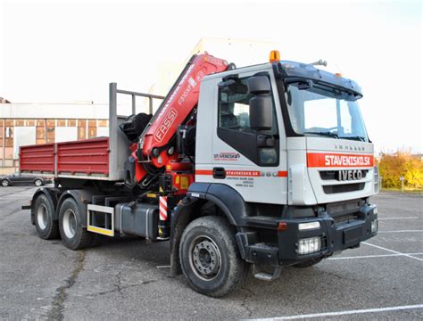 Nákladné auto s hydraulickou rukou doručujúce stavebný materiál