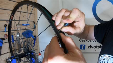 Odborník aplikujúci čerstvú dávku tmelu cez ventil bicykla