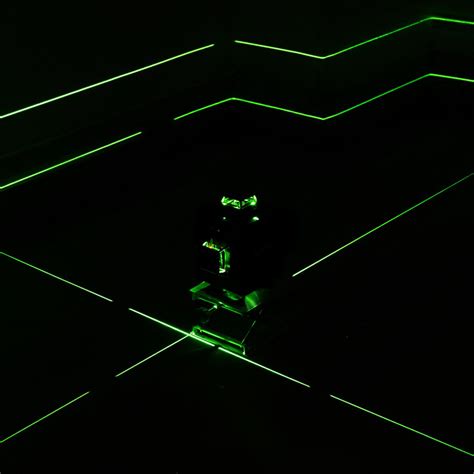Detailný pohľad na zelený krížový laser pri práci v interiéri