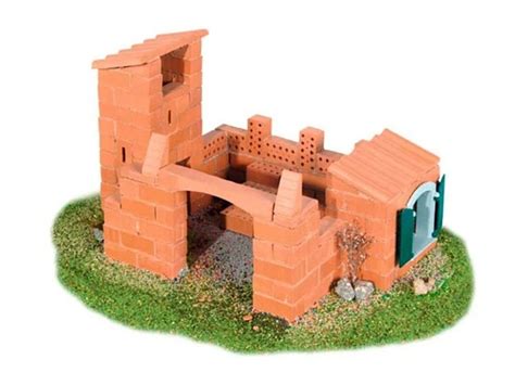 Dieťa stavia miniatúrny hrad z pravých tehál a malty